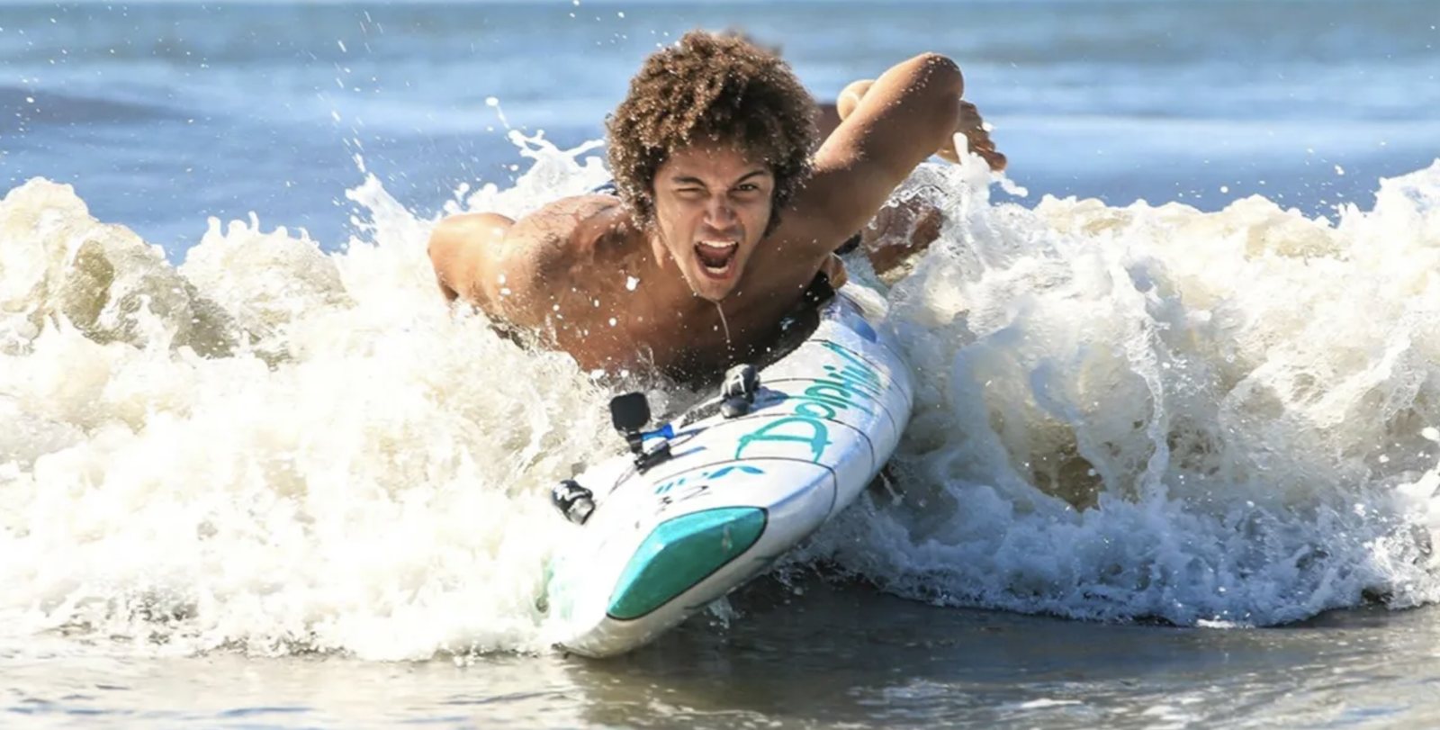 Duval Culpepper paddling a rescue board through surf during Red Bull lifeguard training