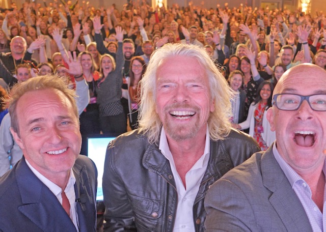 Richard Branson taking a selfie with the Thrive Summit audience